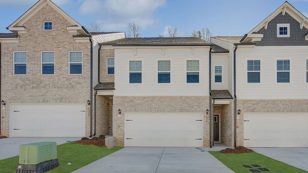 New construction townhome with James Hardie plank siding and brick detailing in townhome community in Riverdale, GA. New construction townhome with James Hardie plank siding and brick detailing in townhome community in Riverdale, GA.