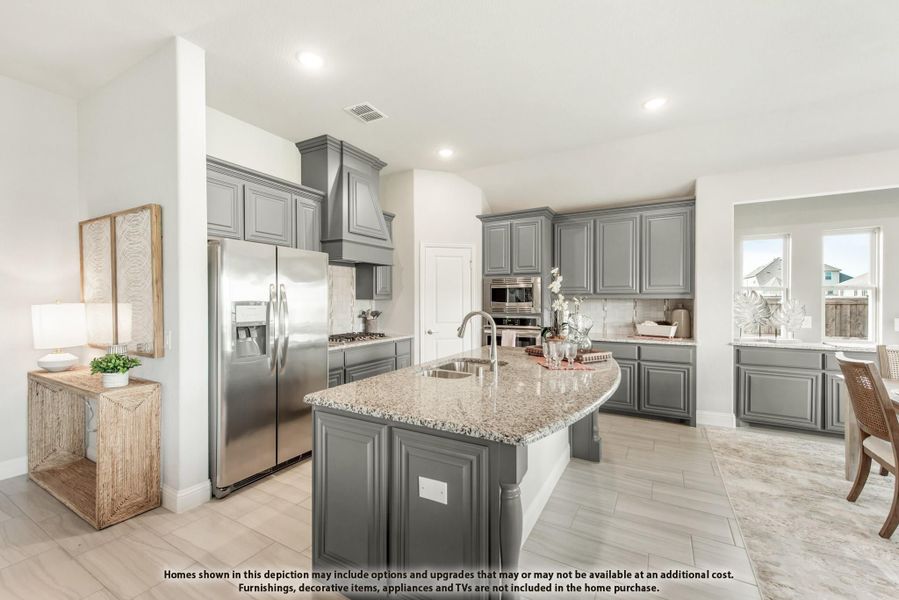Kitchen with gray cabinets, granite island, stainless steel appliances, and light tile floors