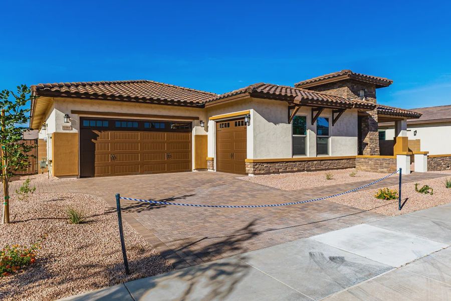Front exterior of a new home in Bellero Estates, Queen Creek, AZ, highlighting curb appeal (Image 1). Front exterior of a new home in Bellero Estates, Queen Creek, AZ, highlighting curb appeal (Image 1).
