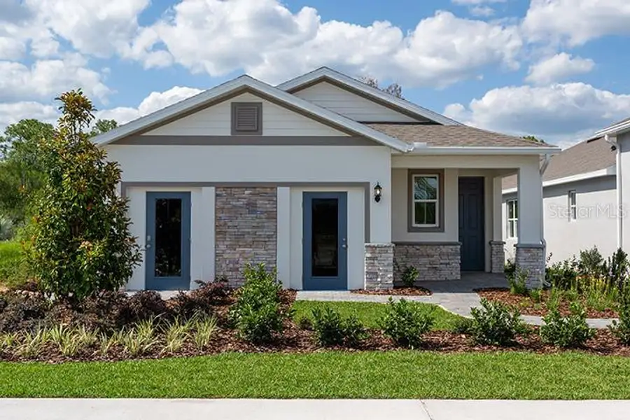 Front exterior of a new home in Liberty Station, Orange City, FL, highlighting curb appeal (Image 1). Front exterior of a new home in Liberty Station, Orange City, FL, highlighting curb appeal (Image 1).