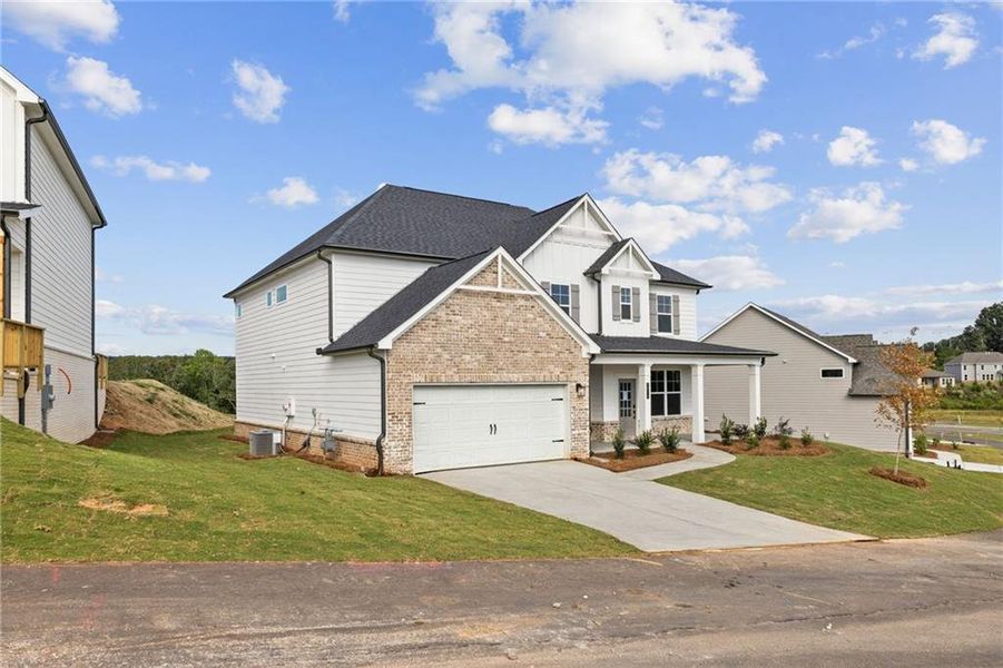 Front exterior of a new home in The Estates at Gainesville Township, Gainesville, GA, highlighting curb appeal (Image 1).