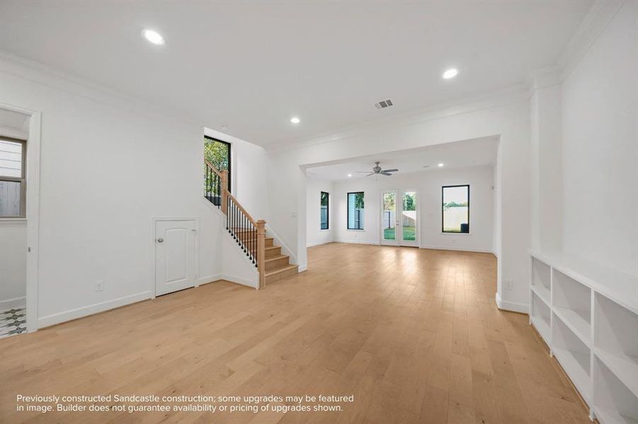 Elegant Ascension: The warm glow of wood floors not only grounds the dining room but also ascends, drawing the eye and spirit upward to the private sanctuaries above.