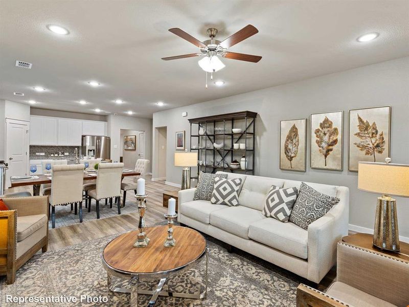 Open-concept living area featuring wood-finish flooring, recessed lighting, and a ceiling fan