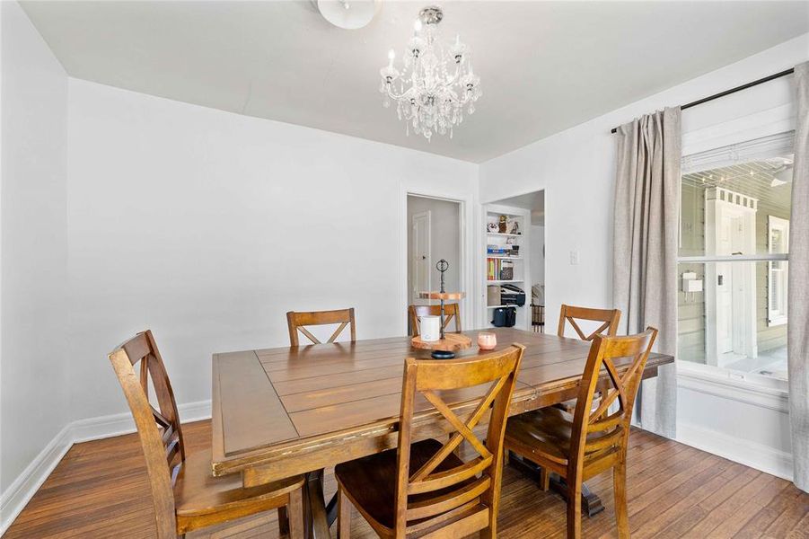 Dining area with hardwood / wood-style floors and a chandelier Dining area with hardwood / wood-style floors and a chandelier