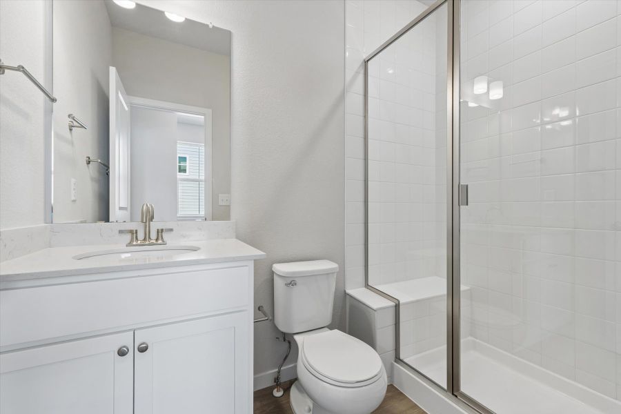 A bathroom with a shower and toilet. A bathroom with a shower and toilet.