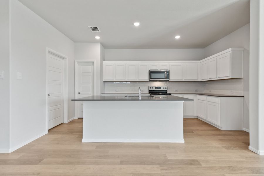 Kitchen in the Hayden home plan by Trophy Signature Homes – REPRESENTATIVE PHOTO