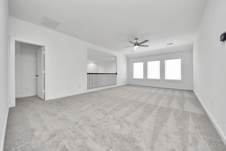 Discover a haven of leisure in this fantastic game room! Whether you're seeking a casual hangout or an adult gaming retreat, this space has it all. Enjoy the luxurious feel of plush carpet underfoot, the expansive ambiance of high ceilings, custom paint that adds a touch of personality, and windows that flood the room with refreshing natural light. Sample photo of completed home with similar floor plan. Actual colors and selections may vary. Discover a haven of leisure in this fantastic game room! Whether you're seeking a casual hangout or an adult gaming retreat, this space has it all. Enjoy the luxurious feel of plush carpet underfoot, the expansive ambiance of high ceilings, custom paint that adds a touch of personality, and windows that flood the room with refreshing natural light. Sample photo of completed home with similar floor plan. Actual colors and selections may vary.