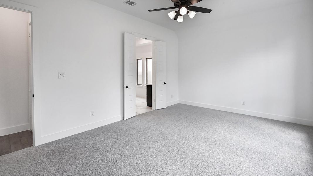 Unfurnished bedroom featuring carpet, baseboards, and ensuite bathroom Unfurnished bedroom featuring carpet, baseboards, and ensuite bathroom