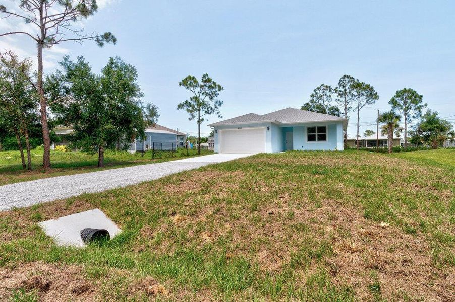 Front exterior of a new home in , Vero Beach, FL, highlighting curb appeal (Image 23). Front exterior of a new home in , Vero Beach, FL, highlighting curb appeal (Image 23).