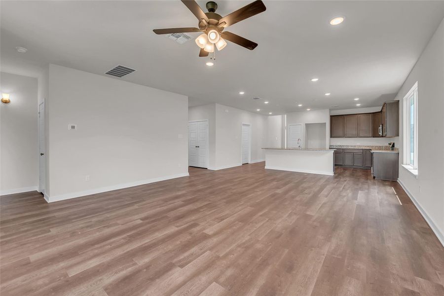 Unfurnished living room featuring recessed lighting, light wood finished floors, and ceiling fan Unfurnished living room featuring recessed lighting, light wood finished floors, and ceiling fan