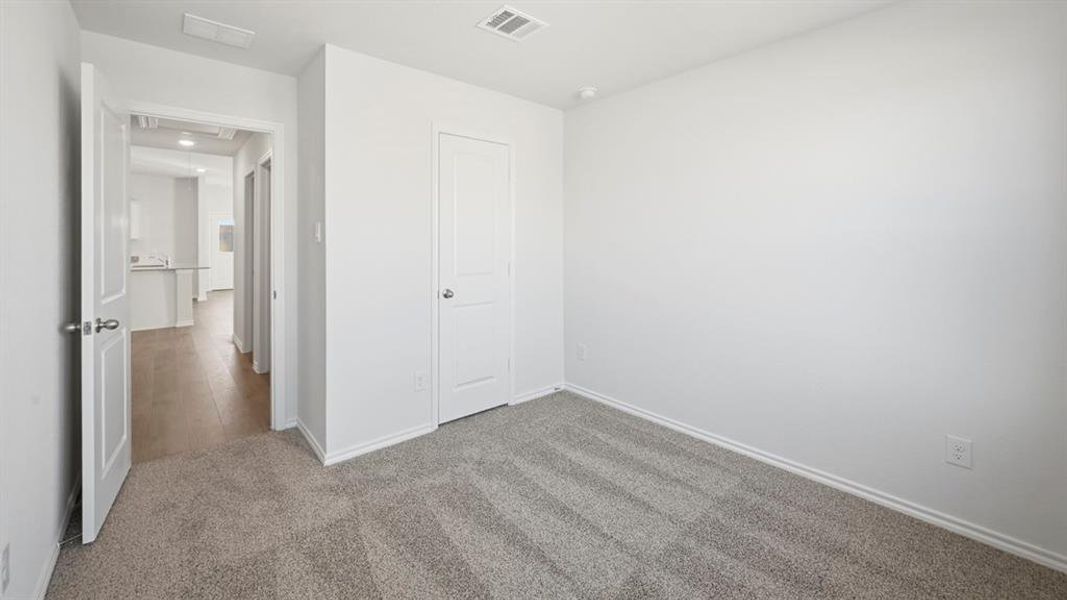 Unfurnished bedroom with carpet floors and baseboards Unfurnished bedroom with carpet floors and baseboards