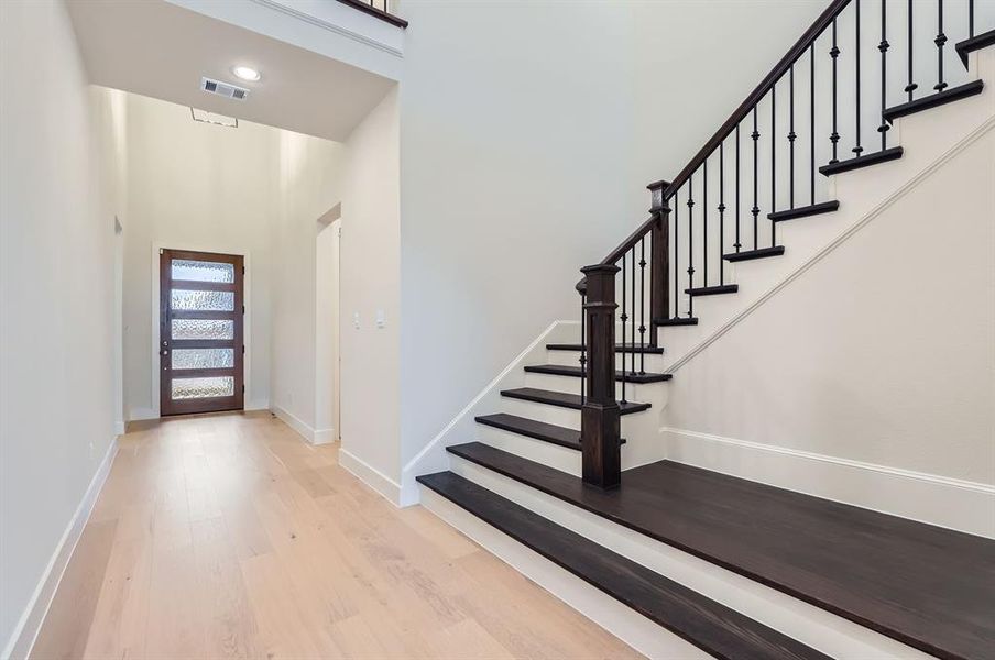 Foyer entrance featuring a high ceiling and light wood-type flooring