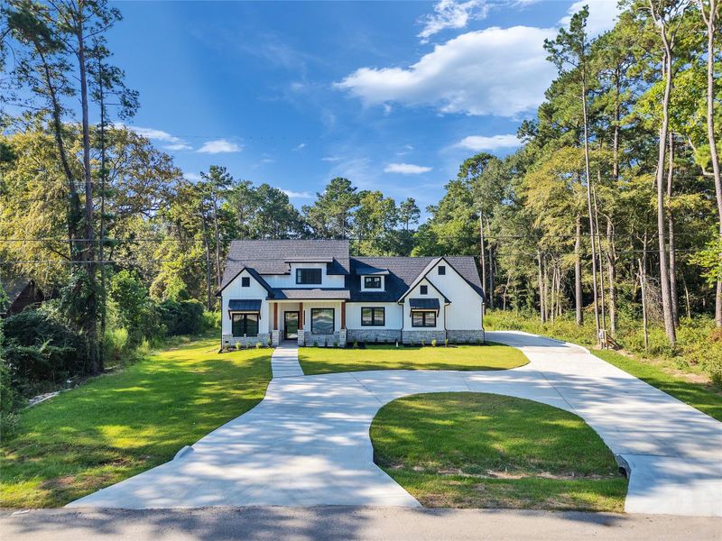 Front exterior of a new home in , Magnolia, TX, highlighting curb appeal (Image 32).