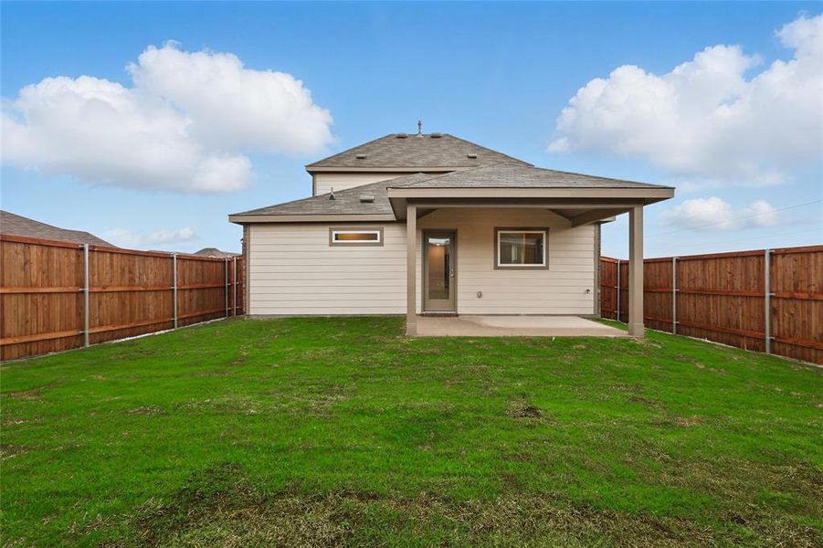 Back of property with a patio area, roof with shingles, and a fenced backyard