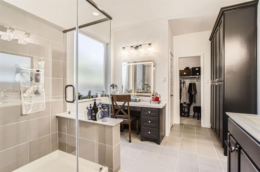 Primary bathroom offers an oversized shower, and a custom vanity area with smart mirror.  This was a recent update of the current home owners.