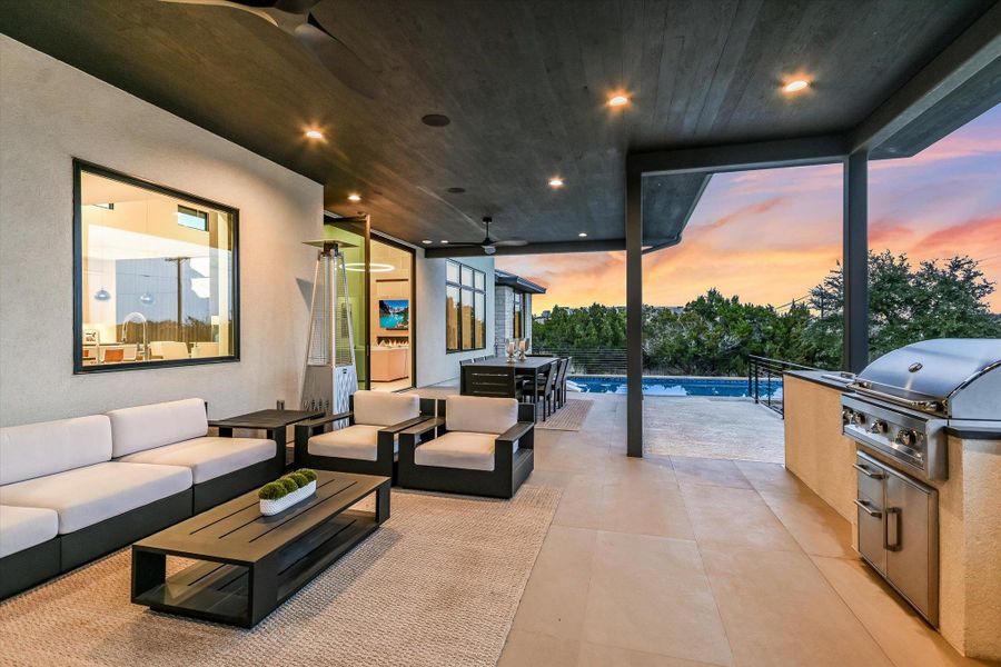 View of patio with an outdoor kitchen with living area, an outdoor pool, and a ceiling fan View of patio with an outdoor kitchen with living area, an outdoor pool, and a ceiling fan