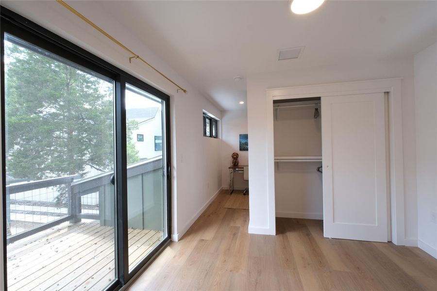 Upstairs Bedroom and large sliding door to deck
