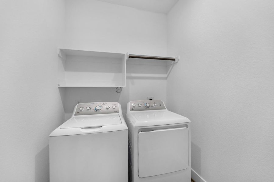 The laundry room layout is carefully planned for optimal workflow with designated areas for washing, drying, and storing.