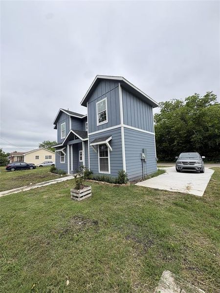 Contemporary two-story residence featuring light blue horizontal siding and vertical board and batten accents Contemporary two-story residence featuring light blue horizontal siding and vertical board and batten accents