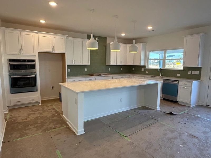 Kitchen featuring the AW Collection® Coastal - White cabinets and sea-glass tile backsplash.