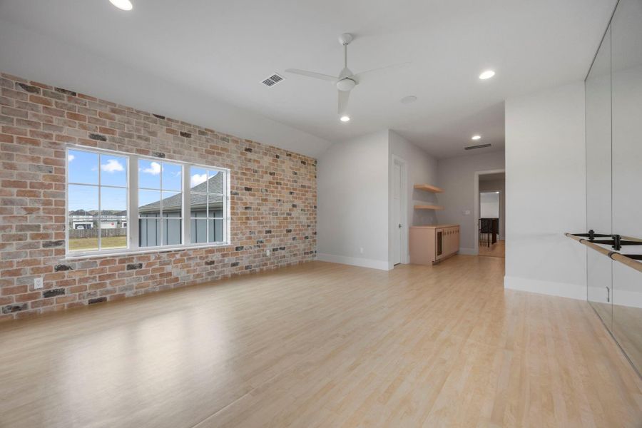 Upstairs ballet/dance studio with brick wall, across from wall of mirrors with ballet bar. This could also be an 8th bedroom with large closet. Upstairs ballet/dance studio with brick wall, across from wall of mirrors with ballet bar. This could also be an 8th bedroom with large closet.