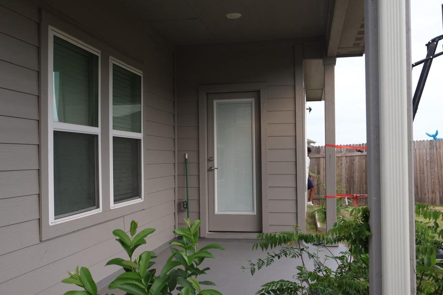 A robust door and sun-filled windows enhance this home's exterior appeal.