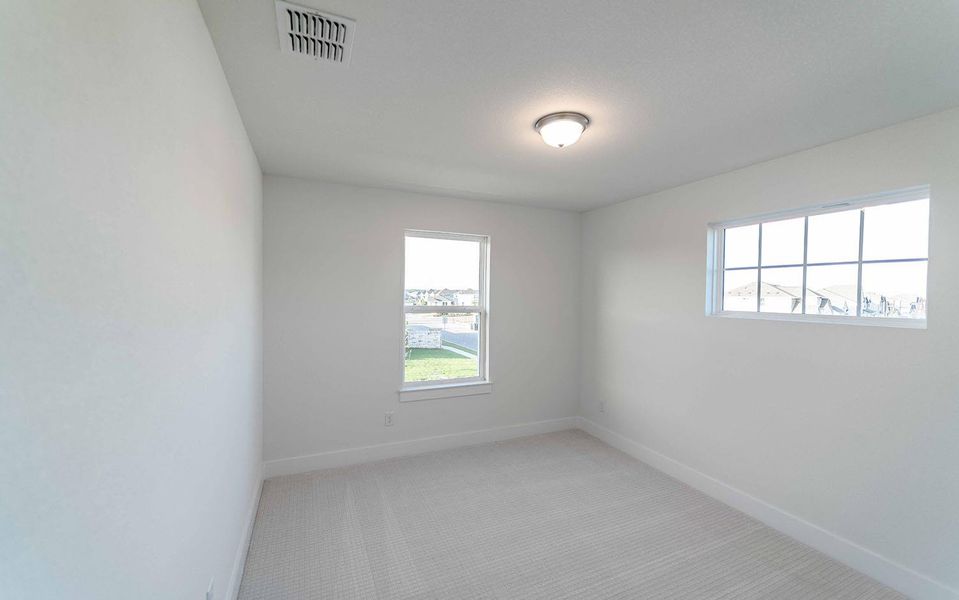 Empty room featuring healthy amount of natural light and carpet floors
