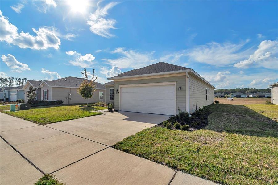 Front exterior of a new home in Liberty Village: Liberty Village - Phase One, Ocala, FL, highlighting curb appeal (Image 2). Front exterior of a new home in Liberty Village: Liberty Village - Phase One, Ocala, FL, highlighting curb appeal (Image 2).