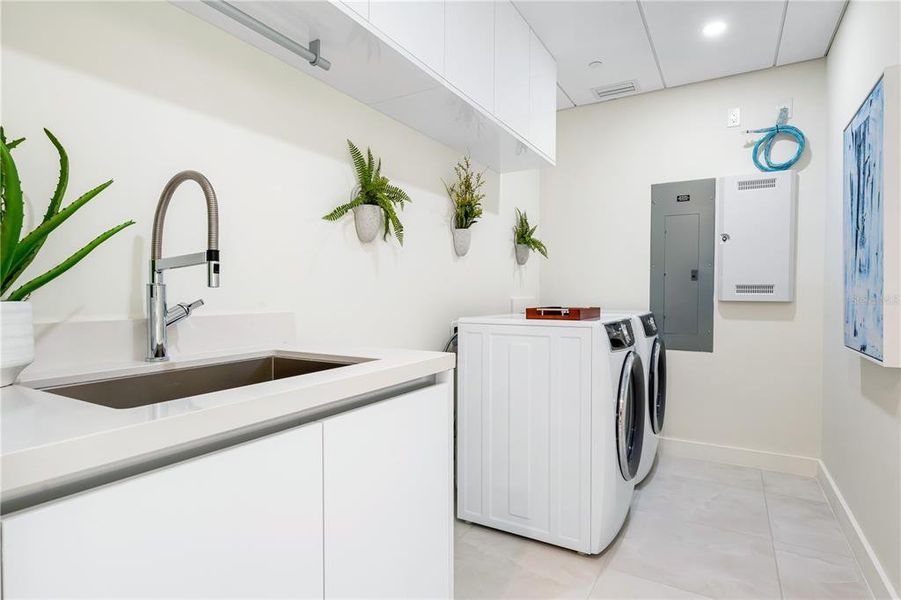 Fully equipped laundry room, sink, wiring for  pre-wired shades that can be installed throughout the condo.