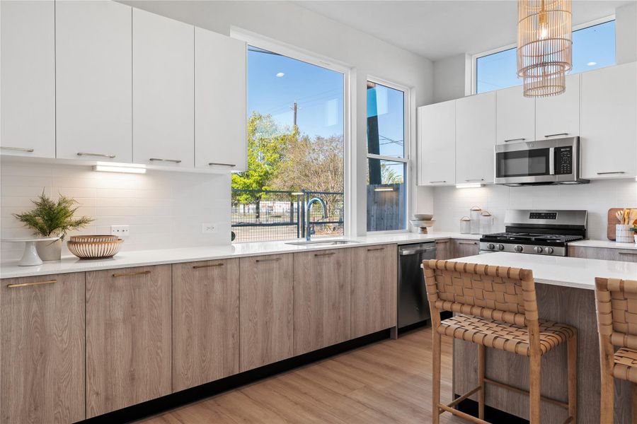 Bright & functional kitchen highlighted by under-cabinet lighting and a large picture window above the sink that floods the kitchen with natural light. Bright & functional kitchen highlighted by under-cabinet lighting and a large picture window above the sink that floods the kitchen with natural light.