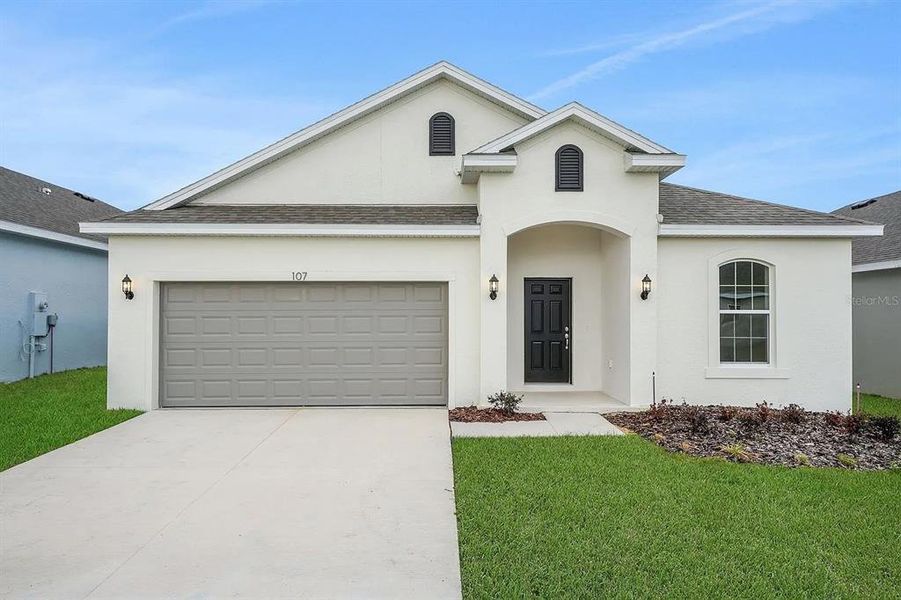 Front exterior of a new home in Cypress Park Estates, Haines City, FL, highlighting curb appeal (Image 21).