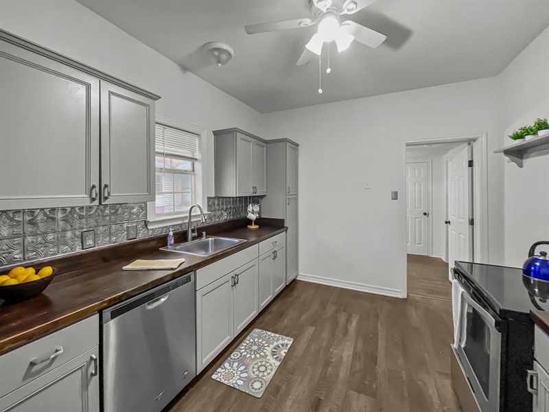 Kitchen featuring appliances & dark wood-type flooring