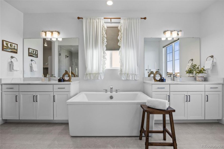 dual vanities and huge soaking tub in Primary bath