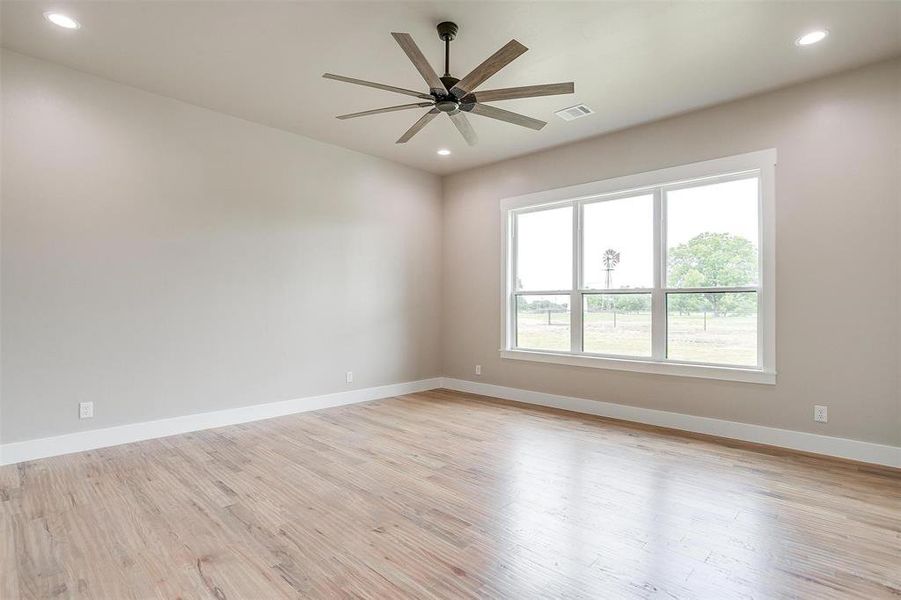 Unfurnished room with a ceiling fan, light wood-type flooring, baseboards, and recessed lighting Unfurnished room with a ceiling fan, light wood-type flooring, baseboards, and recessed lighting
