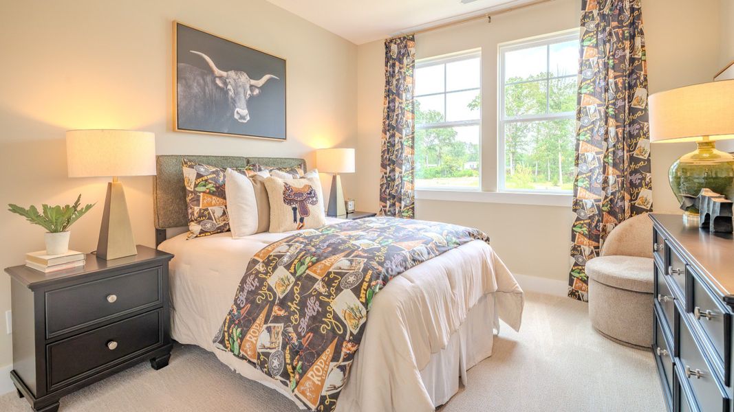 Secondary bedroom with carpet and bright natural light from windows Secondary bedroom with carpet and bright natural light from windows