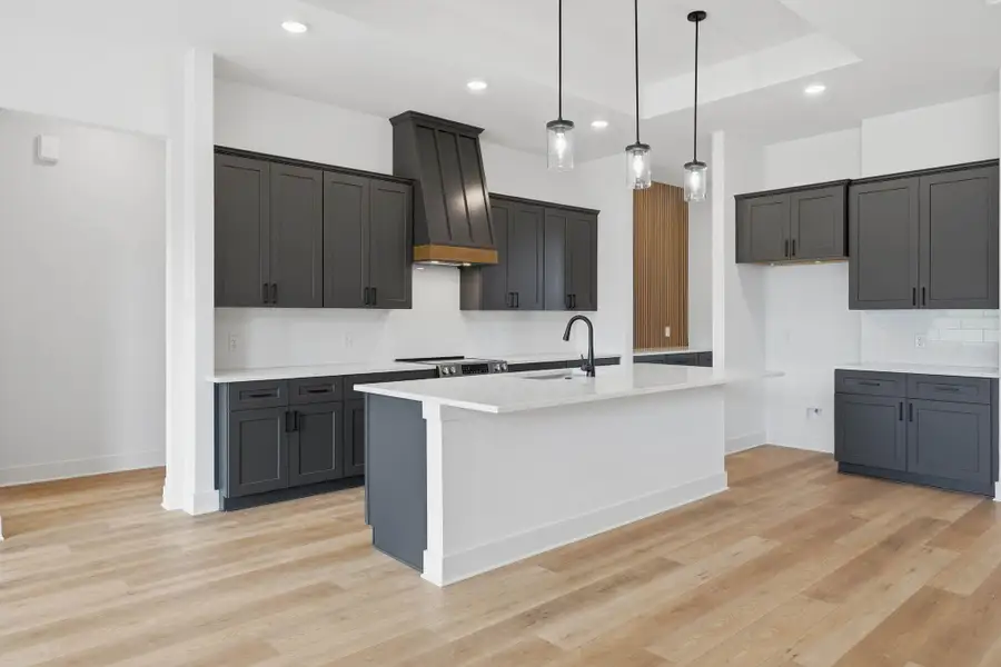 Expansive island provides additional prep space, seating, and a natural gathering point for entertaining.