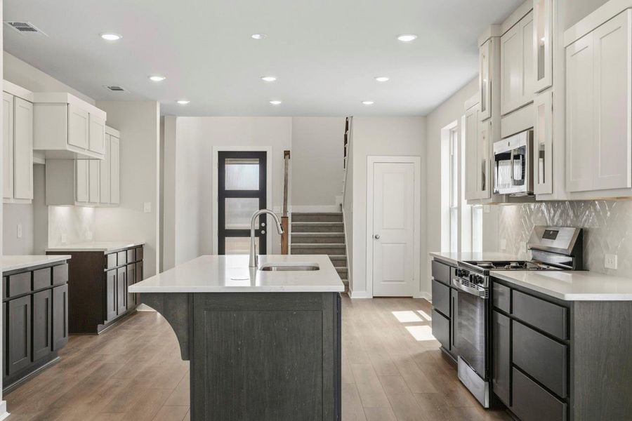 The kitchen flows seamlessly into the dining area, creating a welcoming space designed for gathering, sharing meals, and making memories.