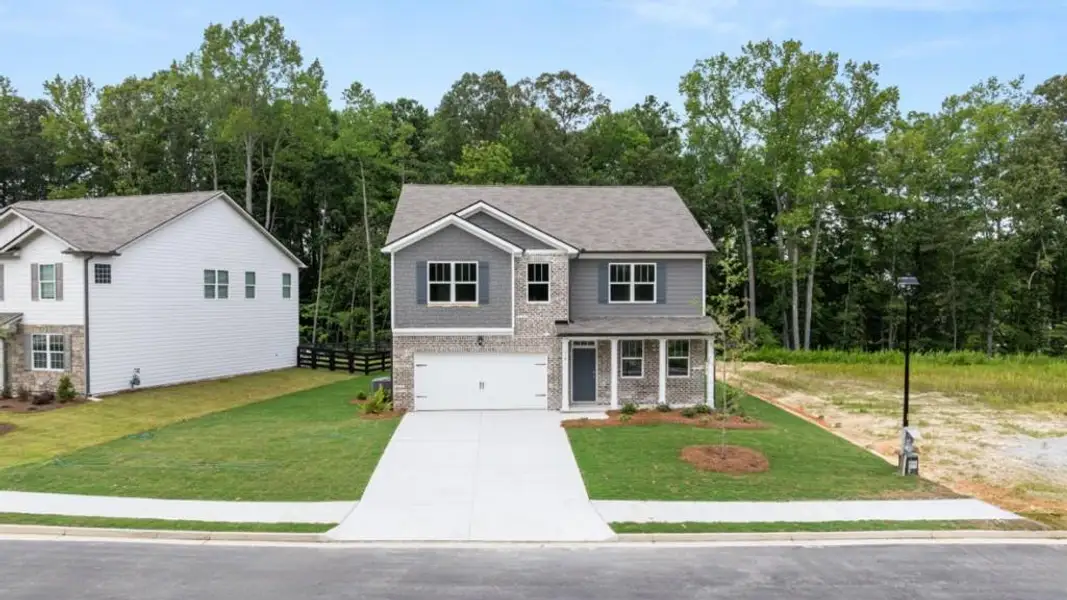 Front exterior of a new home in Northwoods at Mirror Lake, Villa Rica, GA, highlighting curb appeal (Image 1). Front exterior of a new home in Northwoods at Mirror Lake, Villa Rica, GA, highlighting curb appeal (Image 1).