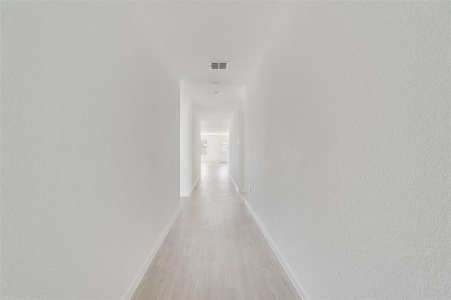 Hall with light hardwood / wood-style flooring