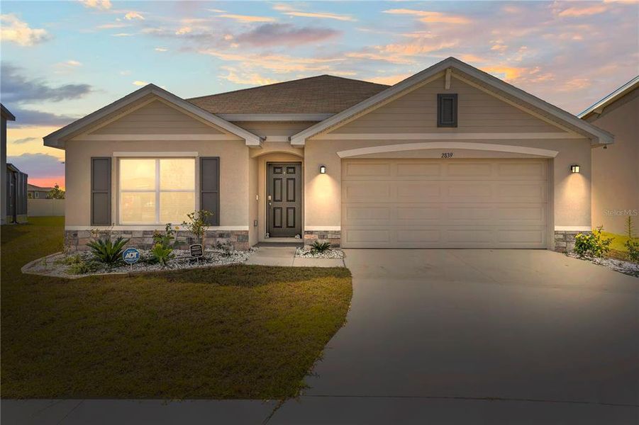 Front exterior of a new home in Berry Bay, Wimauma, FL, highlighting curb appeal (Image 23). Front exterior of a new home in Berry Bay, Wimauma, FL, highlighting curb appeal (Image 23).