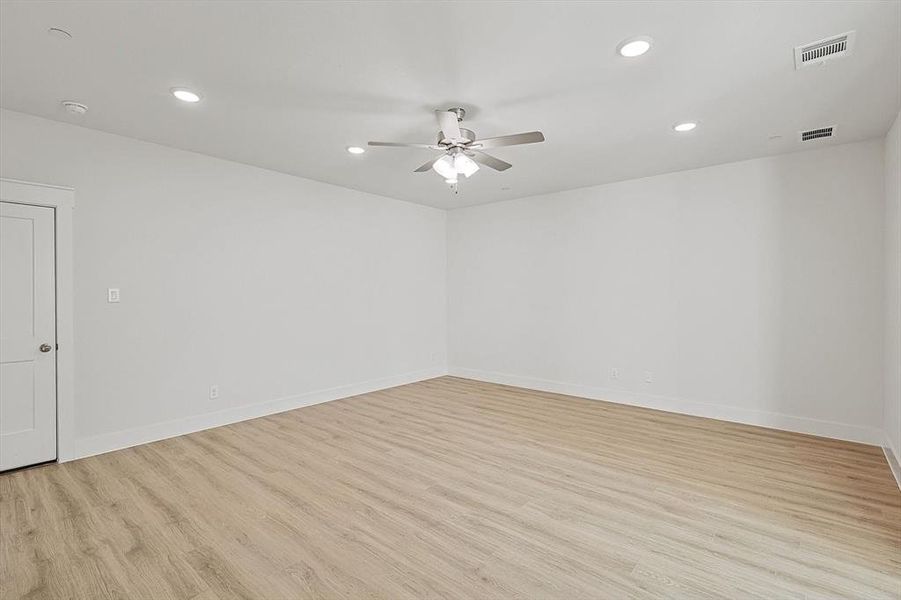 Spare room with recessed lighting, visible vents, light wood-style flooring, and ceiling fan