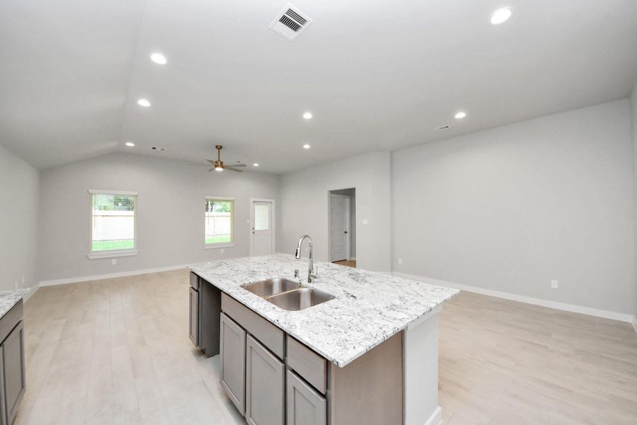 Discover another perspective of this stunning kitchen, generously appointed with an abundance of counter space. Sample photo of completed home with similar floor plan. Actual colors and selections may vary.