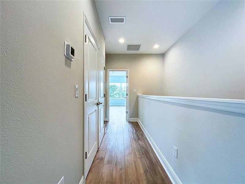 hallway to laundry closet and primary bedroom