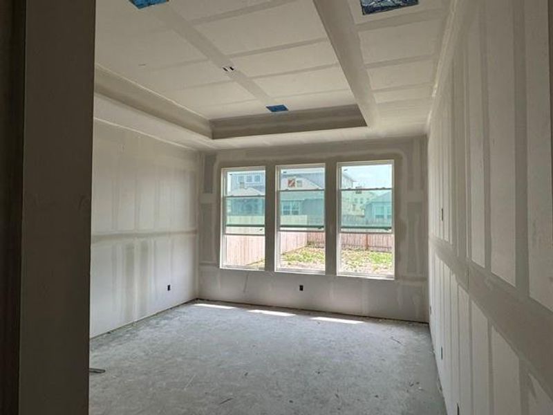 A room under construction offers a blank canvas for customization, illuminated by natural light through ample windows.