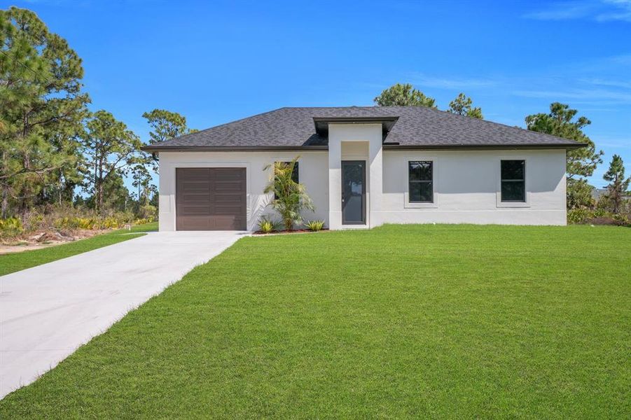 Front exterior of a new home in , Lehigh Acres, FL, highlighting curb appeal (Image 21).