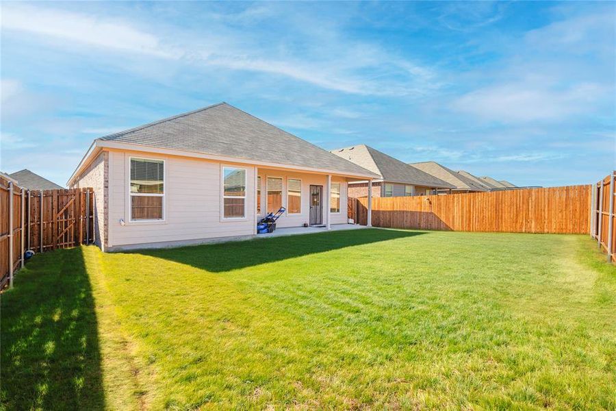 Rear view of property with a patio area, a fenced backyard, and roof with shingles Rear view of property with a patio area, a fenced backyard, and roof with shingles