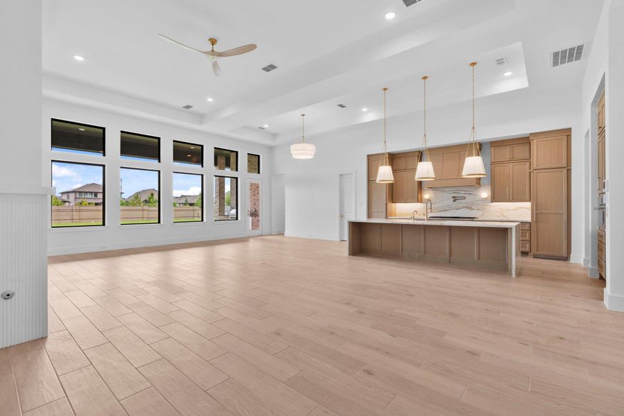 The open floor plan includes space for a breakfast area. Representative image.