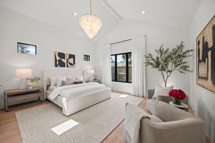 Primary Suite offers arched ceilings w/ designer chandelier, large windows & transoms. A Stately retreat.