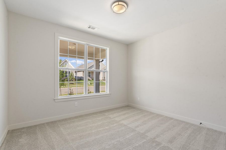 Recessed ceiling light fixture, white trim, single window, and light-colored carpeting Recessed ceiling light fixture, white trim, single window, and light-colored carpeting