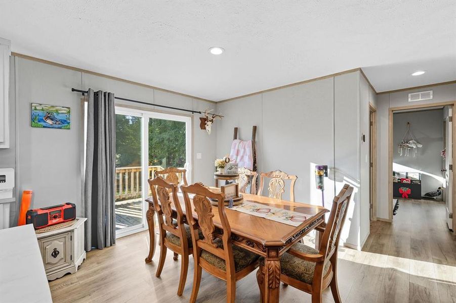 Dining space featuring light wood-style flooring, recessed lighting, and ornamental molding Dining space featuring light wood-style flooring, recessed lighting, and ornamental molding